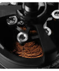 Level Up Your Home Barista Setup With This Dope 58Mm Espresso WDT Tool Featuring Six Heat Resistant Needles Adjustable Depth Control And Hidden Magnetic Storage For Zero Fuss Morning Routines, close-up of coffee grounds in grinder.