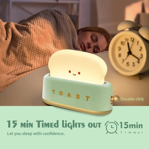 Woman sleeping next to Rechargeable Cute Toaster Lamp With Smile Face, Adorable Night Light Desk Decor, and an alarm clock.