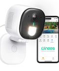 Outdoor Security Camera 2K Ultra Clear Home Surveillance With Color Night Vision AI Human And Pet Detection next to smartphone app.