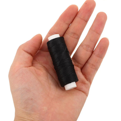 Three Pack Polyester Sailboat Rigging Line Replacement Rope For RC Boats And Model Ships held in hand, black polyester material