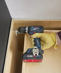 One Half Inch Brushless Hammer Drill And Driver Kit With Core 18v 4ah Battery in use with wood, featuring torque limiter and LED lamp.
