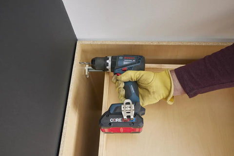 One Half Inch Brushless Hammer Drill And Driver Kit With Core 18v 4ah Battery in use with wood, featuring torque limiter and LED lamp.