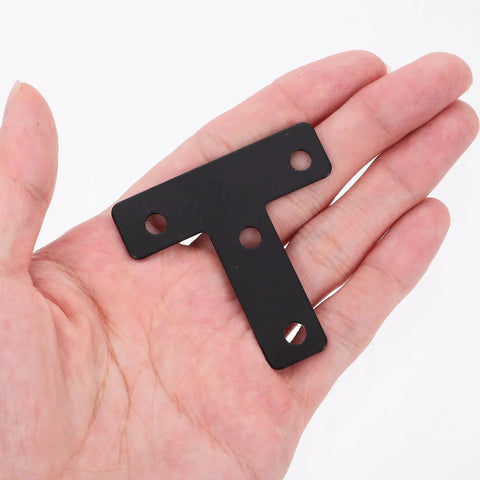 Person holding Black Stainless Steel T Shape Flat Angle Brackets With Countersunk Screw Holes For Chairs And Tables