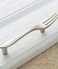 Fork-shaped handle from 3 Piece Funny Knife Spoon Fork Shape Cabinet Pulls Set on kitchen drawer