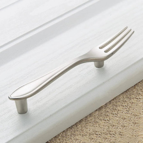 Fork-shaped handle from 3 Piece Funny Knife Spoon Fork Shape Cabinet Pulls Set on kitchen drawer