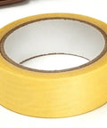 Roll of beige masking tape, typically used for painting and DIY projects