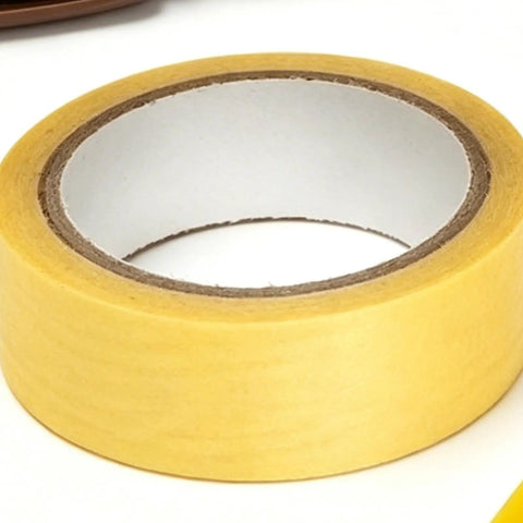 Roll of beige masking tape, typically used for painting and DIY projects