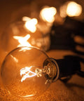 G40 Replacement Light Bulbs 120V 5W Warm White E12 Candelabra Base Dimmable Clear Glass Globe Edison Style 25 Pack glowing indoors