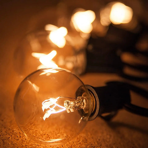 G40 Replacement Light Bulbs 120V 5W Warm White E12 Candelabra Base Dimmable Clear Glass Globe Edison Style 25 Pack glowing indoors