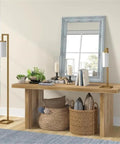 Tall Floor Lamp With Glass Milk Shade In Brass Finish, Stands At 67.75 Inches Tall next to wooden table and mirror in living room