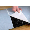 Heavy Duty Rubberized Asphalt Wind And Water Seal Underlayment Single Roll with adhesive backing being unpeeled.