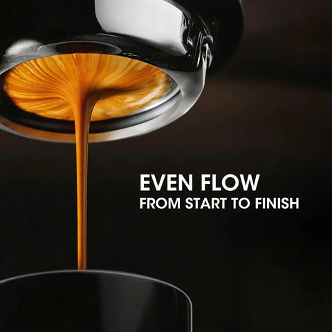 Close-up of espresso shot pouring evenly with magnetic espresso WDT tool for even extraction 10 needle stirrer puck tool visible.