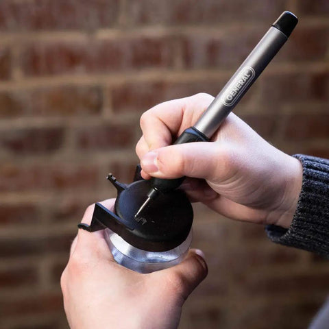 Person using Cordless Engraving Pen For Metal With Diamond Tip Etching Tool Dope For Toys, Sporting Goods, Glass Gifts And More.
