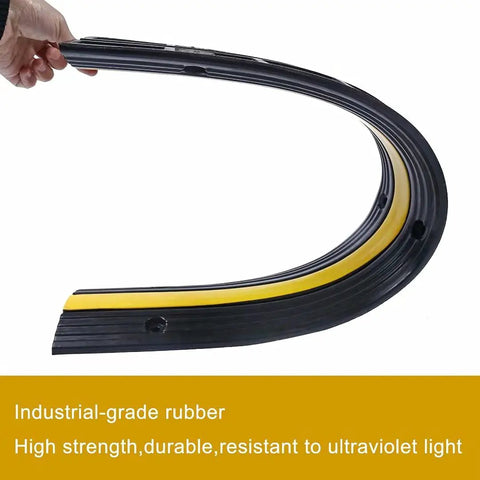 Flexible industrial-grade rubber of Ridiculously Tough Rubber Cable Ramp 1 Channel Cord Cover For Wires And Hoses, 4 Pack shown bent