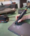 User engraving a design on slate using the Top Tier Cordless Pen Engraver And Digital Soldering Iron Kit With Sweet 20V Battery.