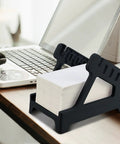 Real Deal Label Roll Organizer Desk Stand For Thermal Printers And Fan Fold Stickers Rack With Open Front Storage beside a laptop.