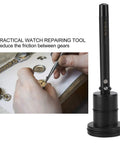 Automatic Watch Oiler Pen for Pro Grade Watch Repair Self Oiling Tool beside watchmaker's hand using tweezers on gears