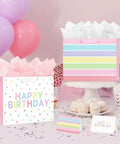 2-Pack 13 Inch Large Happy Birthday Gift Bags With Tissue Paper And Greeting Cards for Girls and Women Party Favors on table