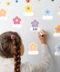 Child writing on 180 Pcs Flower Name Tag Stickers Set For Back To School, Pastel Floral Desk Labels on whiteboard