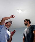 Two people under a Bright 1500 Lumen LED Light You Can Control And Schedule From Your Phone With A Smart Garage Hub Or Wi Fi Opener Super Easy Plug In