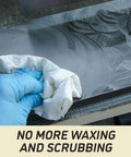 A hand cleaning the surface of an Industrial Grade 16 Inch Parallelogram Jointer With Helical Cutterhead using a cloth.