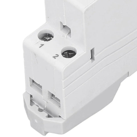 Close-up of a white energy monitor plug connector with labeled connection points, used for energy monitoring applications.