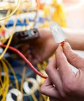 Ceramic high-temp electrical connector with twist cap; close-up of orange wire held by fingers