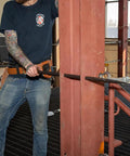Worker using Made in USA Round 7/8 Inch by 36 Inch Connecting Bar for alignment on steel construction site.