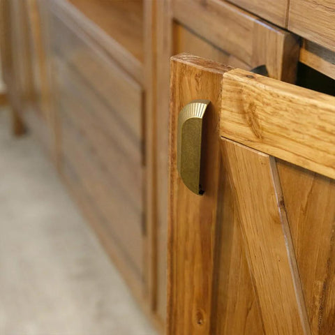 Side view of wooden cabinet door with Six Pack 5 Inch Antique Brass Half Moon Cabinet Cup Handles for kitchen drawers and cabinets.