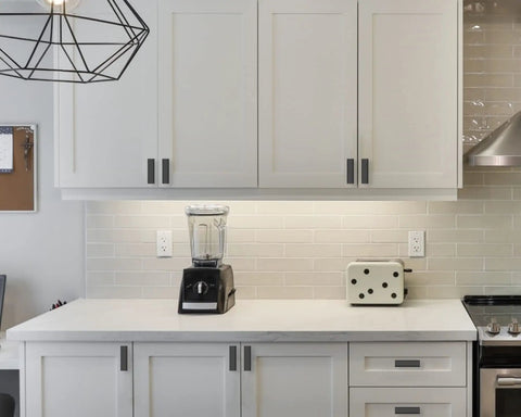 Modern kitchen with Matte Black Cabinet Knobs 20 Pack For Kitchen Cabinets Drawers And Dressers Zinc Hardware visible on white cabinets