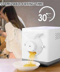 Top Shelf Home Coffee Bean And Peanut Roaster With Auto Rolling Drum pouring roasted grains into a bowl on a kitchen counter.
