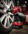 Hard Hitting Brushless Impact Wrench With Friction Ring Unleashes Knockout 1400 Foot Pounds Of Torque For Swift Socket Swaps And Beefy Fastening Tasks Compact 18 Volt Cordless Power Tool Built Like A Tank For Real World Applications, gripping a wheel lug.