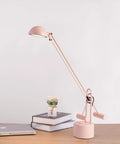 Halotech 29-Inch LED Desk Lamp With Counter-Balance Arm, Polished Steel, 8W LED, Adjustable Shade, on desk beside books and laptop
