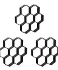 Three black hexagon-shaped paver molds made of durable polypropylene for creating seamless concrete pathways and patios.