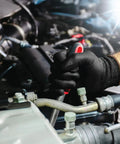 Close-up of hand gripping a wrench while wearing Top Shelf Heavy Duty 13 Gauge Seamless Work Gloves With Polyurethane Palm Coating And Lightweight Polyester Shell For Mechanics And Construction Pros Black Large Pack Of 12 in a vehicle engine bay.