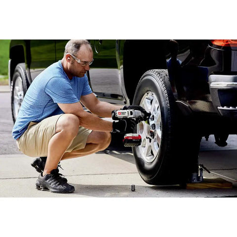 Man using 20V Max Impact Wrench Half Inch Hog Ring Chuck with Variable Speed Trigger for Precision Control on car tire