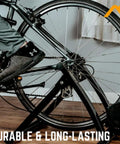 Replacement Quick Release Rear Skewer For Road And Mountain Bike Trainers in a home gym setup with bike on trainer.