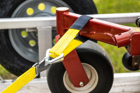 2 Inch By 24 Inch Premium Axle Tie Down Strap With D Rings securing cargo on flatbed trailer