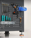 Heavy Duty Steel Workbench For Garage And Auto Shop Tough As Nails Industrial Maintenance Bench with organized tools on pegboard.