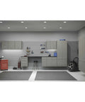 Modern garage with wall cabinets, tool storage, and clean workspace under bright overhead lighting.