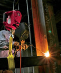 Heavy-Duty 120V AC Electric Winch With 1000 Lb Capacity For Vehicle Recovery, No-Load Line Speed Of 13.8 Fpm, Built Tough For Real-World Rugged Jobs, Easy To Use And Durable Winch That Replaces Outdated Come-Alongs. worker using heavy-duty electric winch during steel beam welding