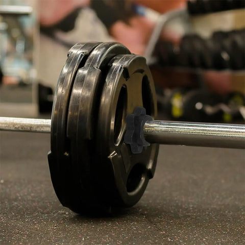 Close-up of barbell with 8 Pack Spinlock Barbell Collars For Weightlifting Durable Plastic Nut Locks in a gym setting.