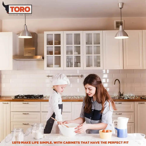 Mother and child baking in a kitchen with modern cabinets and pendant lights.