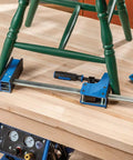 Beefy 24-Inch Parallel Bar Clamps For Woodworking holding chair on workbench