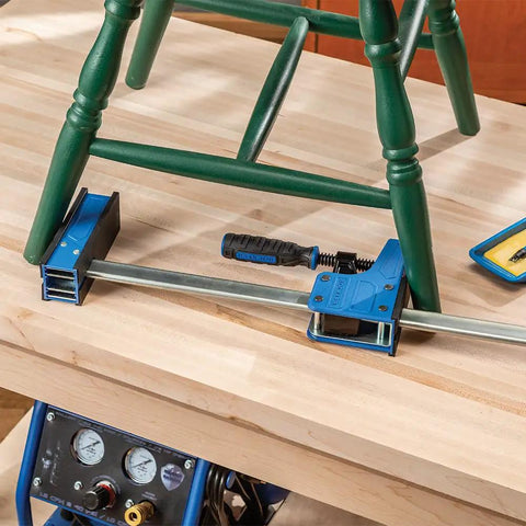 Beefy 24-Inch Parallel Bar Clamps For Woodworking holding chair on workbench