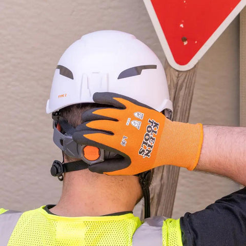 Worker wearing Knit Dipped Cut Resistant Work Gloves With Nitrile Coated Palms For Maximum Grip And Flexibility ANSI A1 Rating