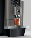 Premium Top Shelf Fully Automatic Coffee Machine Featuring Cold Brew Options And Thirty Four Recipes With Smart Touchscreen pouring cold brew over ice.