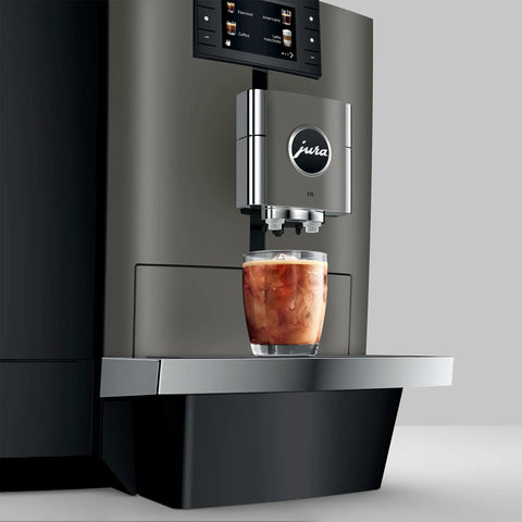 Premium Top Shelf Fully Automatic Coffee Machine Featuring Cold Brew Options And Thirty Four Recipes With Smart Touchscreen pouring cold brew over ice.
