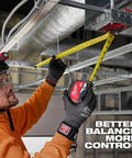 25 Ft Magnetic Tape Measure With Stiff Straight Blade For Better Balance And Control, Precision Oriented Design For Quick Accurate Readings, Red Handle, Durable Steel Tape For Pro Level Framing And DIY Projects. worker measuring ceiling framing with yellow steel tape