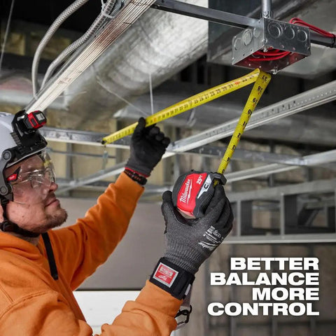 25 Ft Magnetic Tape Measure With Stiff Straight Blade For Better Balance And Control, Precision Oriented Design For Quick Accurate Readings, Red Handle, Durable Steel Tape For Pro Level Framing And DIY Projects. worker measuring ceiling framing with yellow steel tape
